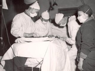 Older image of doctors performing a procedure on a patient